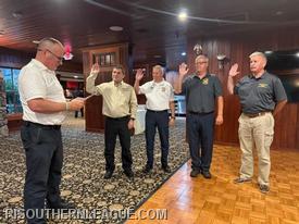 Outgoing President Tom Reed swears in Treasurer Alex Potts, Vice President Steve Pinch, President Scott Barber, and Director John Mackay. Secretary Chris Koretski could not be present.