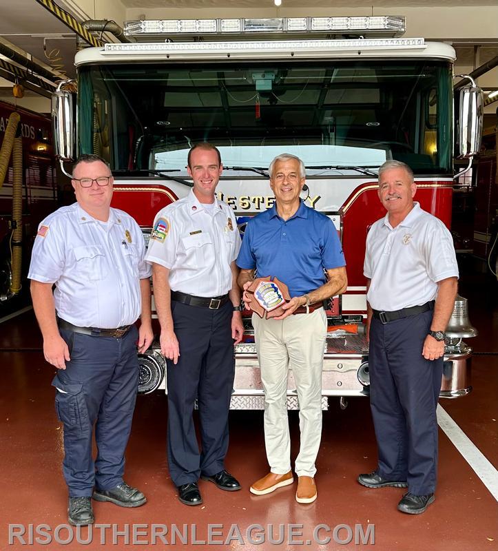 President Justin Lee, Secretary Chris Koretski, Senator Dennis Algiere, and Director John Mackay with the award at Westerly Fire Headquarters. Chiefs Kettle and Reed were tied up at an emergency scene and unable to attend the presentation. 
